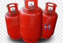 Domestic LPG gas cylinder delivery at a household with distributor worker unloading cylinders